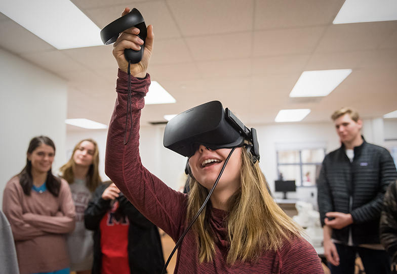 A student uses a virtual reality headset in the IDEAlab of the JD Williams Library