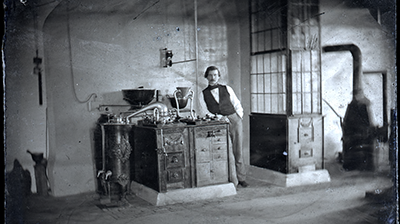 Edward C. Boynton, standing next to equipment in lab. Photo dates between 1856-1861.