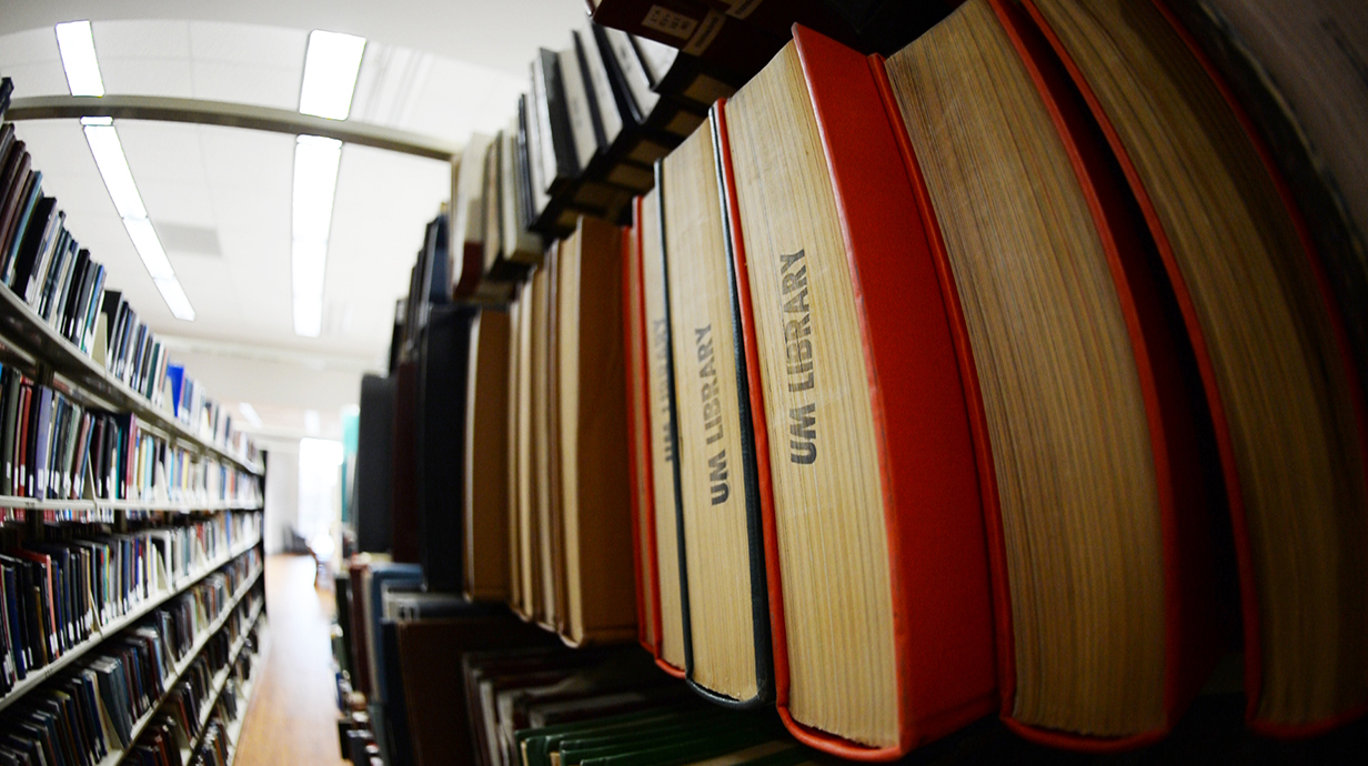 Shelf with UM Library books on it