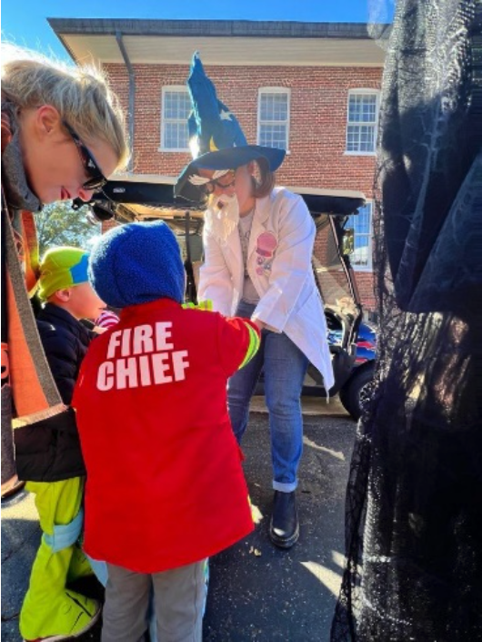 Staff Passing out Candy to Willie Price Students