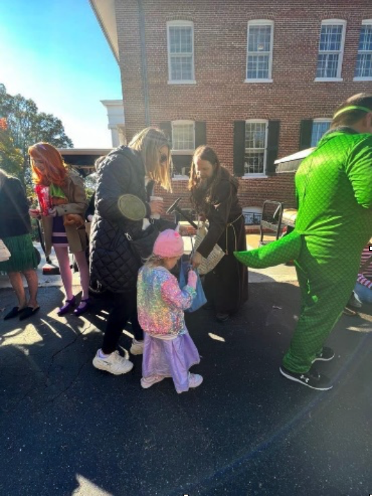 Staff Passing out Candy to Willie Price Students